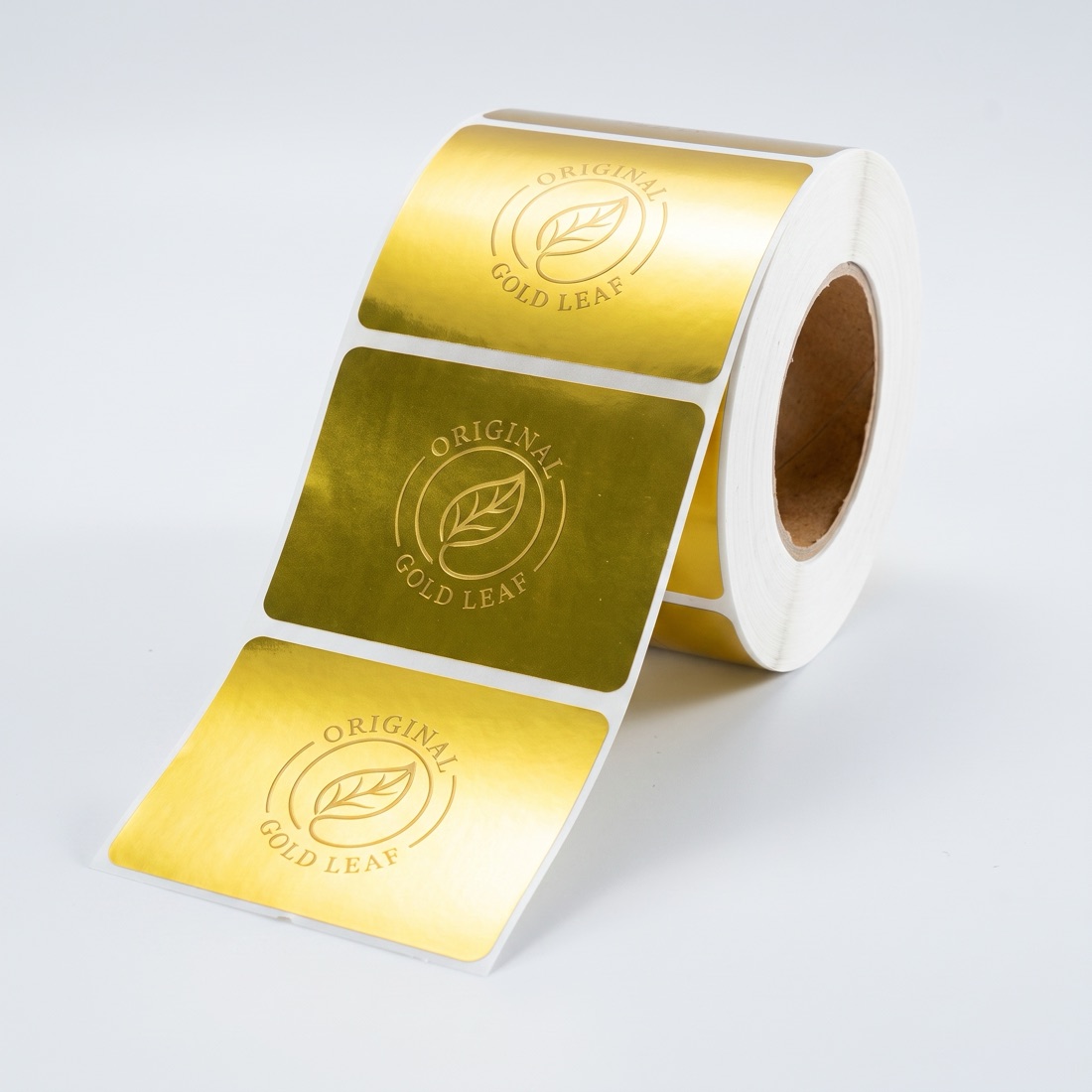 Custom printed product label roll on a studio backdrop, made by Euphora