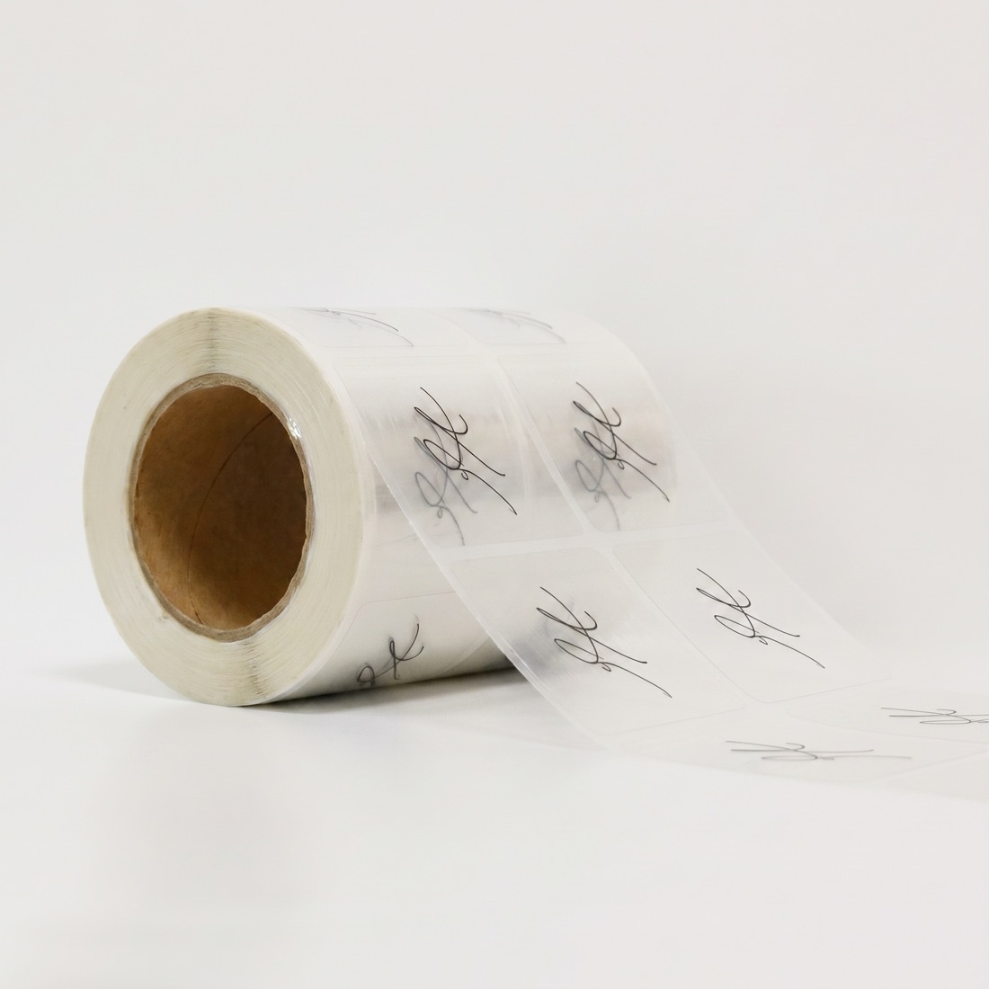 Custom printed product label roll on a studio backdrop, made by Euphora