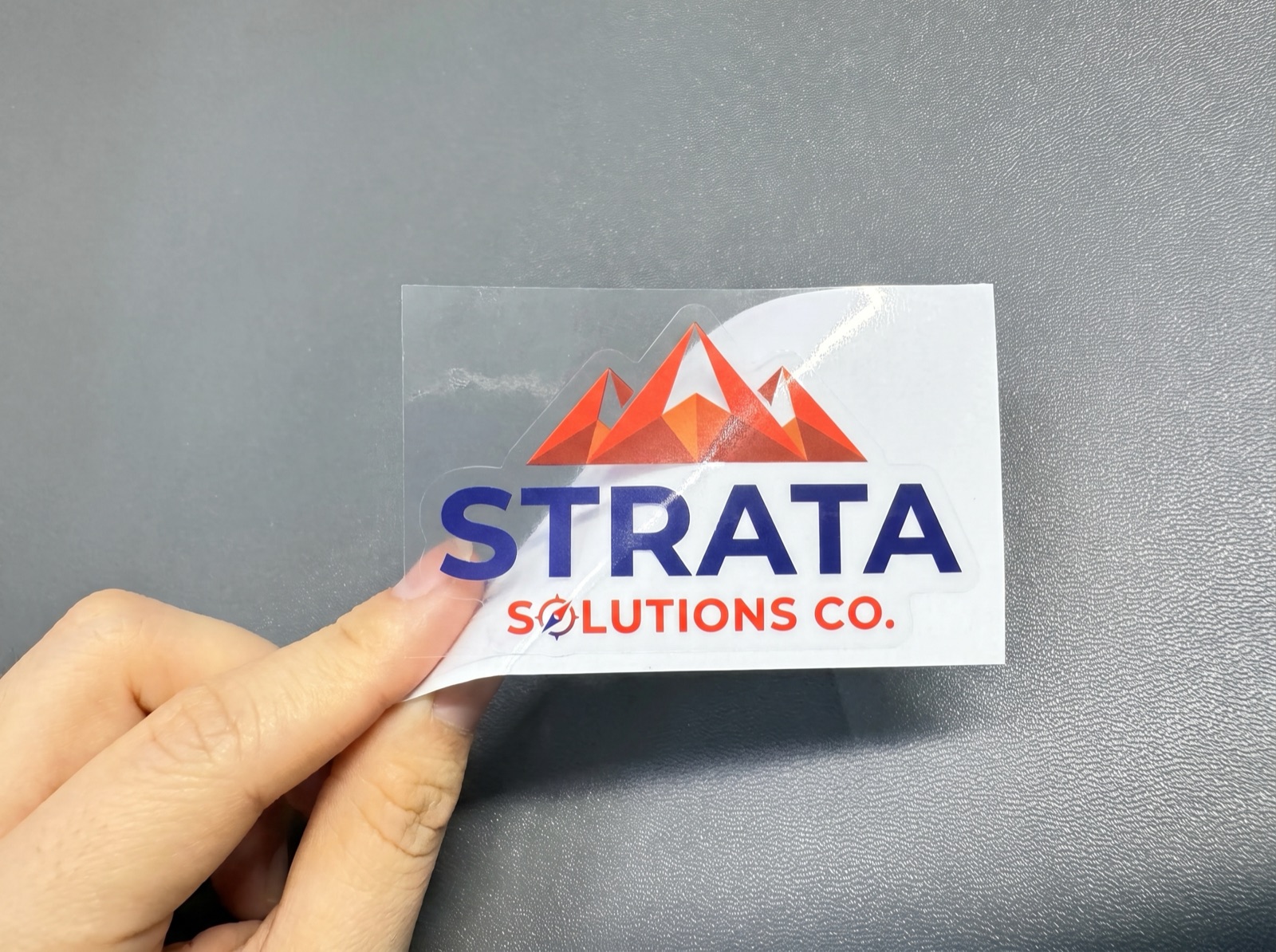 Custom printed product label roll on a studio backdrop, made by Euphora