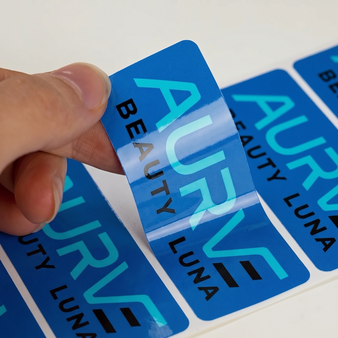 Custom die-cut vinyl stickers peeled and fanned out, printed by Euphora